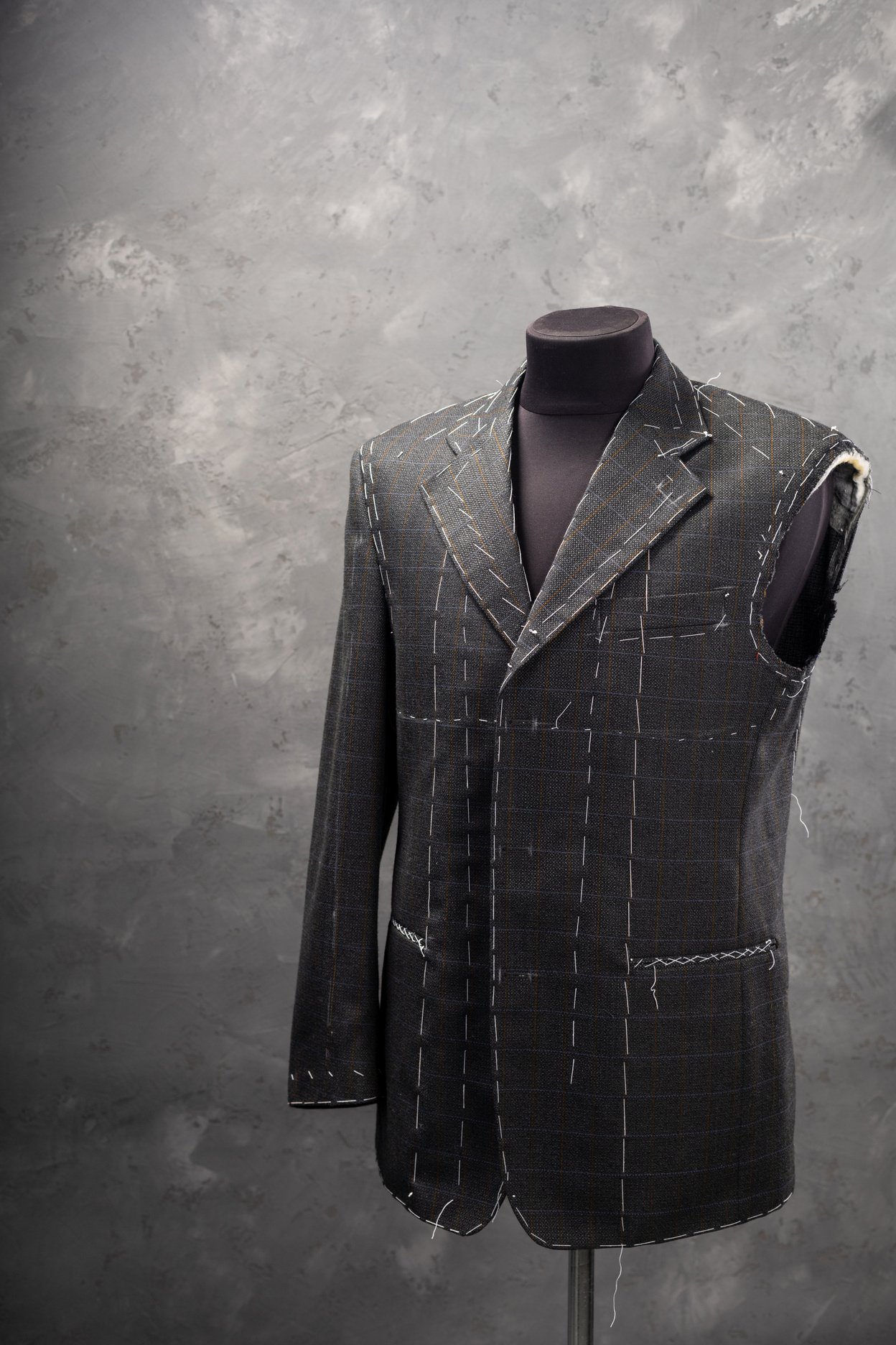 suit jacket on male tailor mannequin, creative concept in clothes atelier